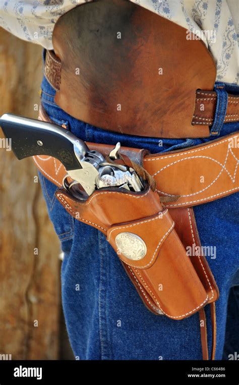 Traditional Colt-style single action revolvers in holsters at a fast ...