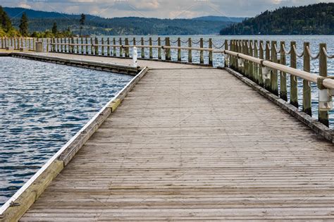 Wooden pier or dock extending into a stock photo containing walk and path | Architecture Stock ...