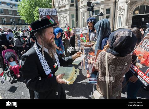 An anti-Zionist Neturei Karta Jew hands out leaflets about their ...