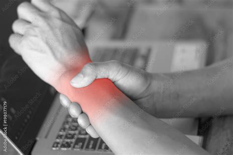 man holding her wrist pain from using computer. Office syndrome hand pain by occupational ...