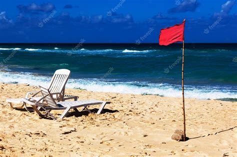 Premium Photo | Red flag on the beach