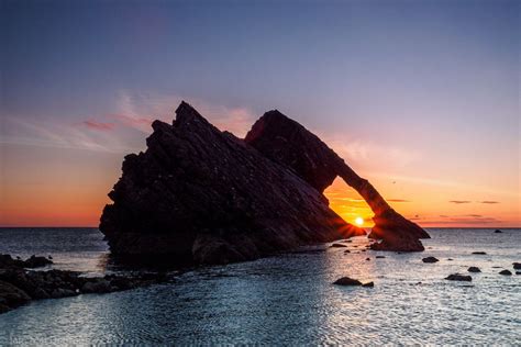 Sunrise Through Bow Fiddle Rock | Sunrise, Sunrise pictures, Beach weather