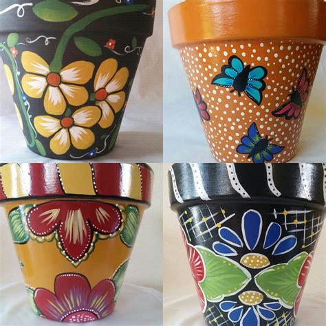 three flower pots with designs painted on them