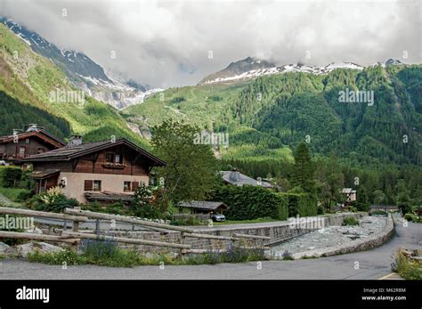 View of creek, houses and alpine landscape in a cloudy weather at Argentiere. An adorable ski ...