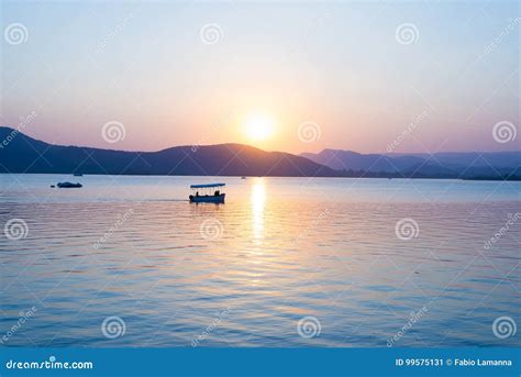 Boats Floating on Lake Pichola with Colorful Sunset Reflated on Water ...