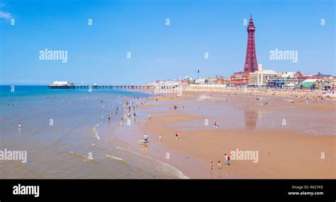 Blackpool beach summer Blackpool tower and North pier Blackpool uk with people on the sandy ...