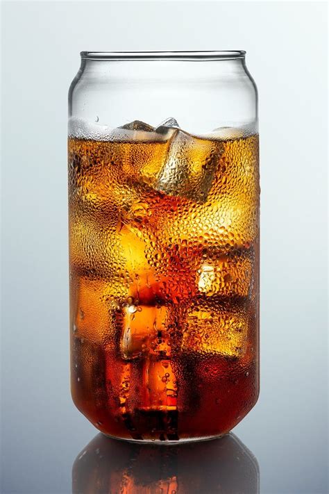 Download premium psd / image of Cold carbonated drink over ice cubes in ...