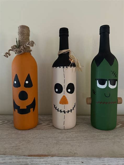 three bottles decorated to look like halloween characters