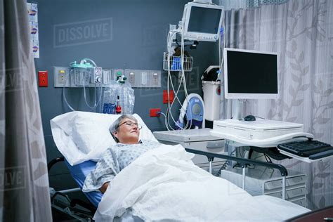 Mixed race patient in hospital bed - Stock Photo - Dissolve