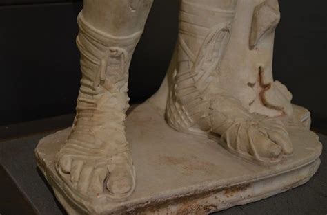 Bottom of a statue of a Roman soldier, he wears a military… | Flickr