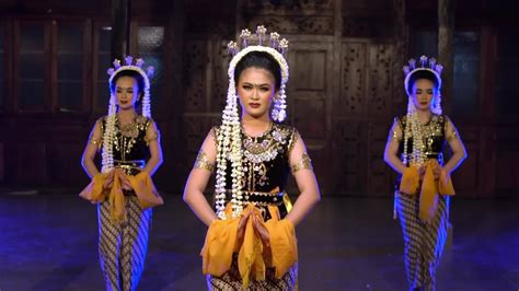 a group of Javanese dancers performs a traditional dance in front of ...