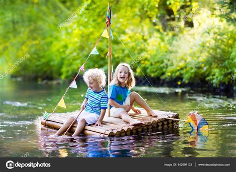 Kids on wooden raft Stock Photo by ©FamVeldman 142691133