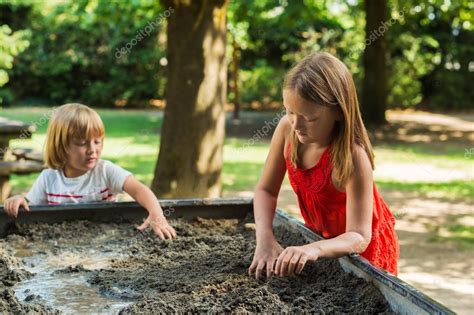 Cute kids playing in a sandbox Stock Photo by ©annanahabed 81153706