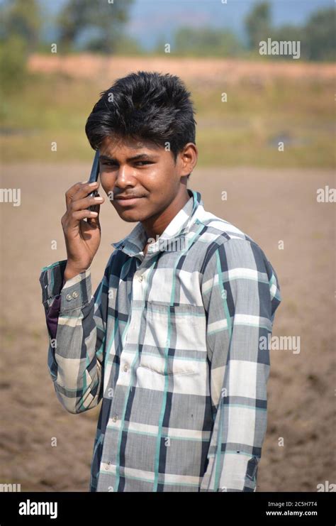 TIKAMGARH, MADHYA PRADESH, INDIA - NOVEMBER 12, 2019: Indian village boy smiling through a ...