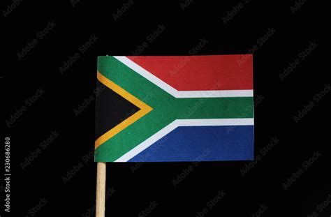 A national flag of South Africa on toothpick on black background. The ...