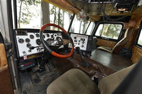 the interior of an old fashioned truck with wood trim and gauges on the ...