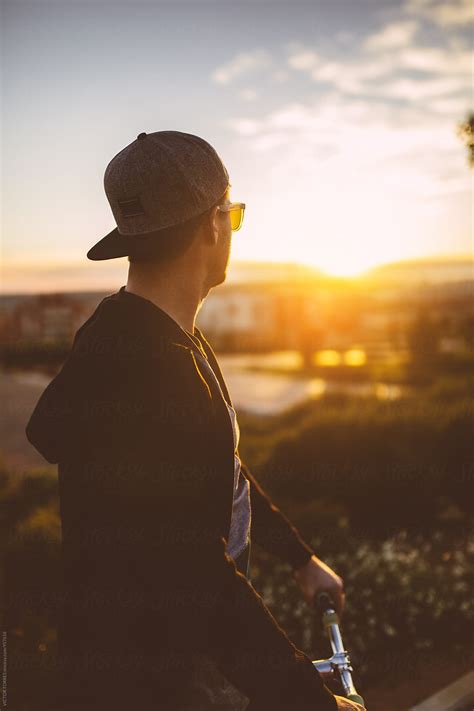 "Young Man Looking At Sunset During A Bicycle Ride" by Stocksy ...