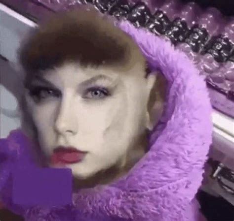 a woman with purple hair and makeup is wearing a fur coat in front of a mirror