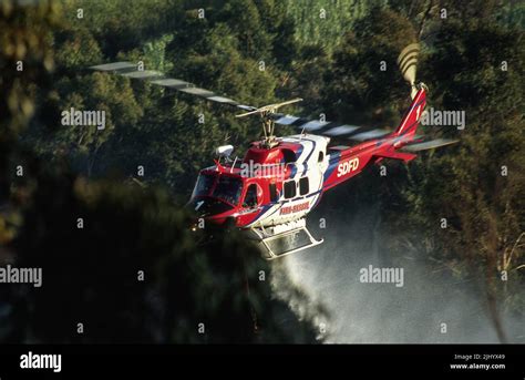 San Diego Fire-Rescue Copter 1 making a water drop on a wildland (brush) fire in San Diego ...