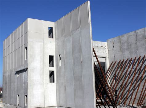 a building that is being built on the side of a road in front of a blue sky