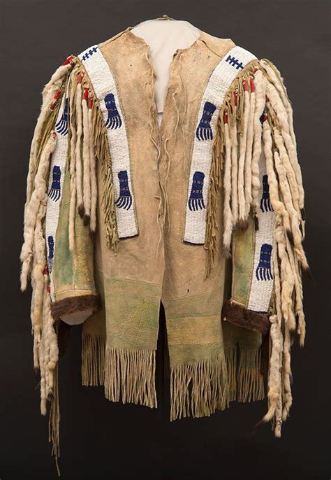 an old native american jacket with fringes on it