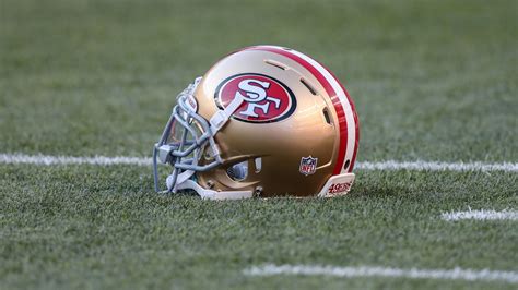 Golden Color Helmet With San Francisco 49ERS Log On Green Grass 4K HD ...