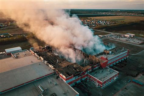 Aerial view of demolished burning industrial building by fire, huge ...