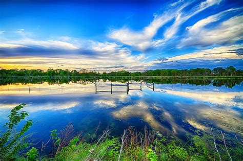 HD wallpaper: calm body of water overlooking trees under cloudy sky at daytime | Wallpaper Flare