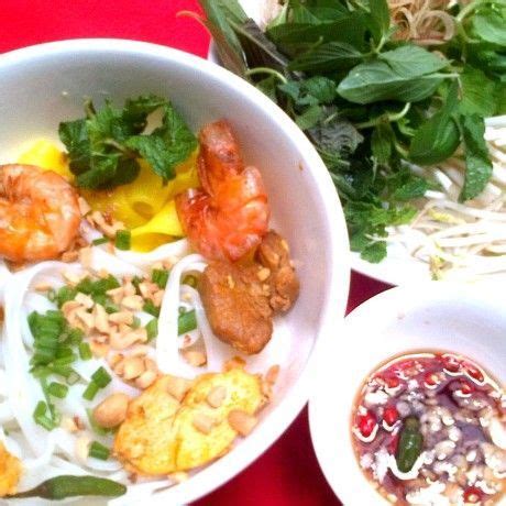 a bowl filled with shrimp, rice and vegetables next to another bowl ...