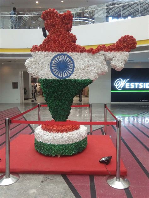 a sculpture made out of flowers in the middle of a mall