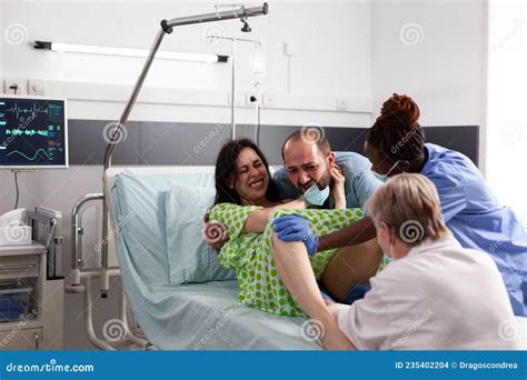 Young Woman Giving Birth To Child in Hospital Ward Stock Photo - Image of assistance, delivery ...