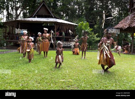 dh PNG village culture ALOTAU PAPUA NEW GUINEA Traditional native dancers children dancing ...