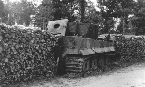 Knocked out Tiger I tank used as a filer in a woodpile wall. Either France or Italy. 1944. : r ...