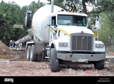 A concrete truck pouring concrete at a house foundation Stock Photo - Alamy