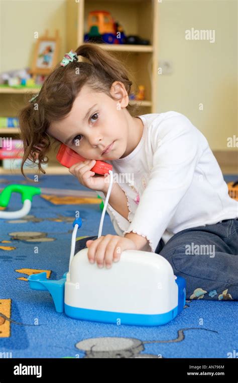 Little girl playing with toys Stock Photo - Alamy