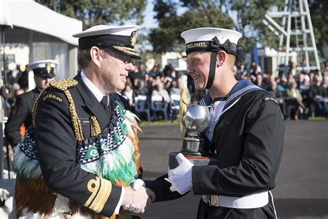 Chief of the Royal New Zealand Navy, awards the top graduate of basic training in his batch ...