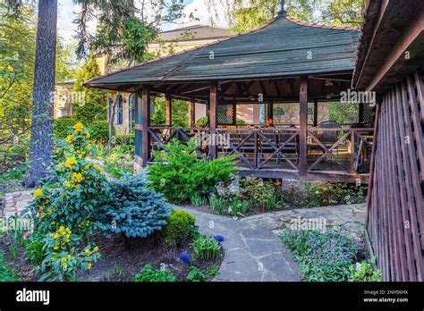 big pavilion for barbeque and wonderful plants in garden near cottage ...