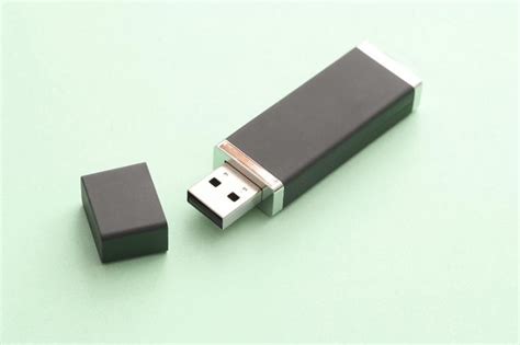 Open USB flash storage drive for a computer on a green background with copy space in a ...