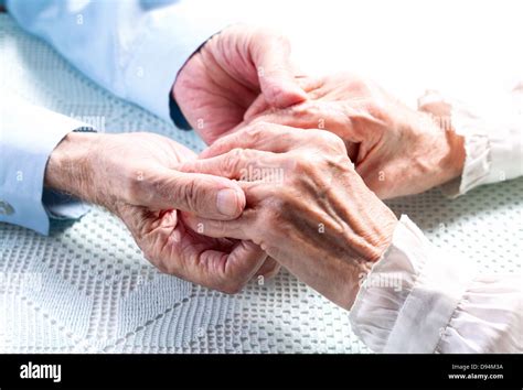 Old people holding hands. Closeup Stock Photo - Alamy