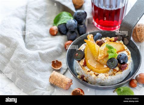 Baked camembert with pears and grapes Stock Photo - Alamy