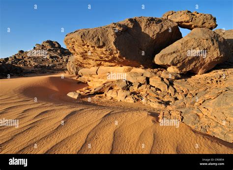 Sandstone rock formation and sand dunes, Adrar Tekemberet, Immidir ...