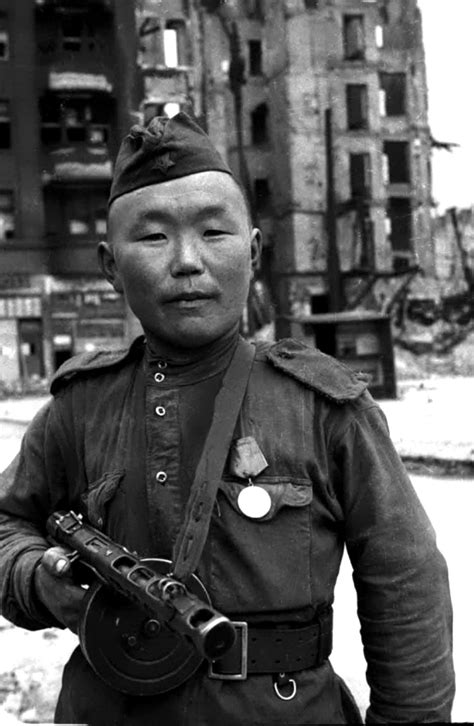 A Red Army soldier with his PPSh-41 in Berlin in 1945 : r/MilitaryHistory