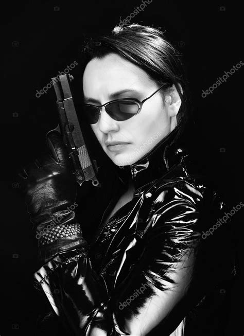 Secret agent woman with gun Stock Photo by ©claudioarnese 65517959