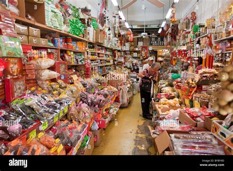 Shopping in Honolulu's Chinatown. An older couple shops in a small old-style food store in ...