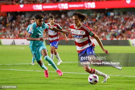 Alvaro Carreras of Granada CF and Lamine Yamal of FC Barcelona during ...