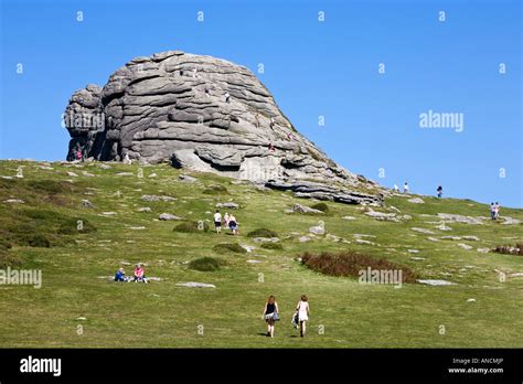 Tourists visiting Hay Tor rock formation on Dartmoor Devon England UK ...