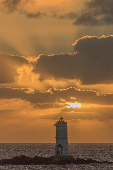 "Lighthouse At Sunset" by Stocksy Contributor "Sky-Blue Creative" - Stocksy