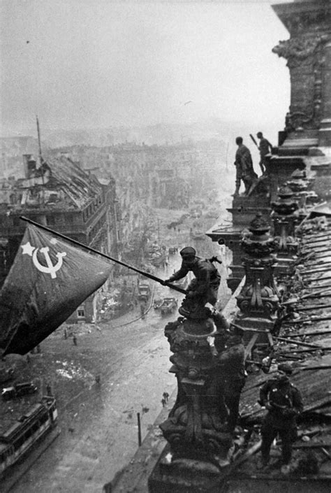 Soviet Union soldiers raising the flag on the roof of Reichstag building in Berlin, Germany in ...