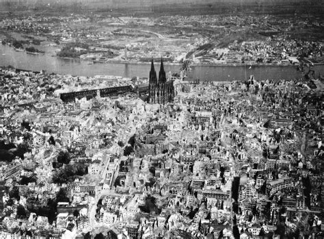 The Cologne Cathedral stands tall amidst the ruins of the city after Allied bombings, 1944