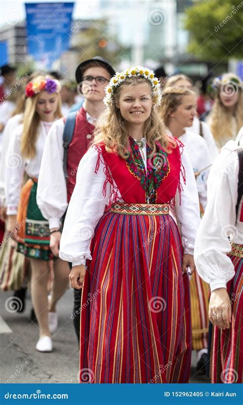 Estonian People In Traditional Clothing Walking The Streets Of Tallinn ...